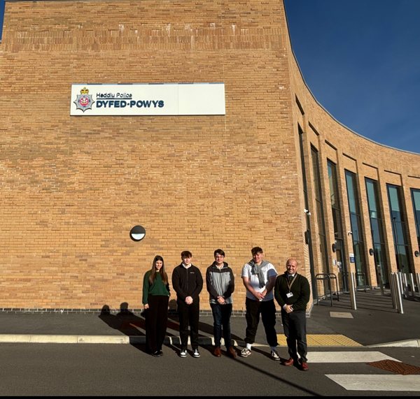 PCC Dafydd Llywelyn and Youth ambassadors outside Dafan Custody Suite.